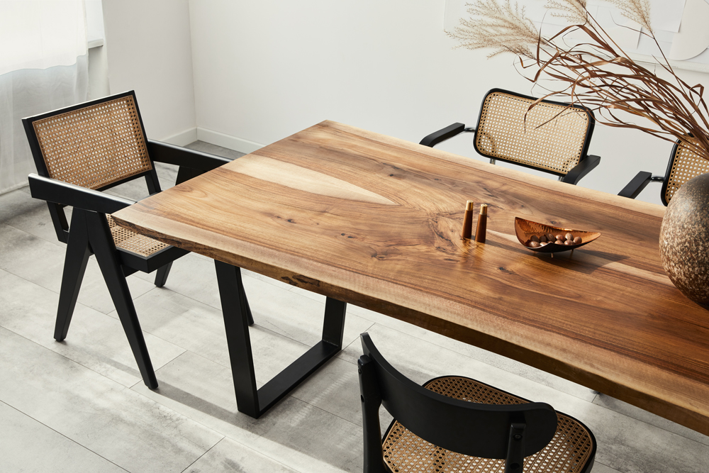 Minimalist composition of dining room interior with wooden table, design chairs and elegant personal accessories. Template.